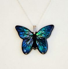 "- Brilliant Blue, Turquoise, Aqua, Green & Black Paua Shell Large Butterfly in a stunning Pendant, or Necklace with 925 Sterling Silver Oval Cable Chain. Photos #1-4. - Paua Shell is assembled and set in Resin for stability and long life. - Blue and Green shades predominate but others including Turquoise, Aqua, Pink & Black will be seen. Each piece is assembled and no 2 are exactly alike. - Stylish 925 Sterling Silver Bail (hanger). - 925 Sterling Silver 1.7 x 2.4mm Oval Cable Chain included is Blue Sterling Silver Necklace With Inlay, Blue Necklace With Round Inlay, Unique Blue Necklace With Inlay, Elegant Turquoise Butterfly Jewelry, Turquoise Butterfly Sterling Silver Jewelry, Blue Butterfly Sterling Silver Jewelry, Turquoise Butterfly Jewelry For Gifts, Turquoise Butterfly Jewelry For Gift, Handmade Turquoise Butterfly Jewelry