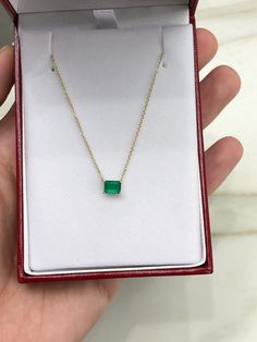 Featured here is a fine quality 0.80-carat stunning, East to West emerald necklace in fine 14K yellow gold. Displayed in the center is a vivacious green emerald with great clarity, accented by a simple four-prong gold mount, allowing for the emerald to be shown in full view. The earth mined, green emerald has a desirable lush green color with excellent qualities. An 18 inch is attached to the emerald pendant. This necklace is ideal for everyday use and is the perfect accessory to any outfit. Tot Green Diamond-cut 14k Gold Necklace, 14k Gold Green Diamond Cut Necklace, 14k Gold Emerald Cut Emerald Necklace, Dainty Emerald Necklace For Formal Occasions, Emerald Cut Yellow Gold Diamond Necklace Gift, Emerald Cut Green Diamond Necklace Gift, Emerald Cut Diamond Necklace As A Gift, Green Diamond Cut Necklace For Gift, Green Emerald Necklace