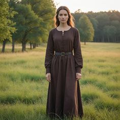 This dark brown Viking-inspired dress combines historical elegance with a simple, timeless design. Featuring a lace-up front and a black belt, this gown is perfect for medieval reenactments, Viking festivals, or Renaissance fairs. Its rich brown color adds a touch of authenticity, making it ideal for anyone looking to capture the essence of Nordic and medieval fashion. Whether you're attending a historical event or participating in a reenactment, this comfortable and stylish dress offers both practicality and a nod to the past. Embrace the rustic charm of Viking culture with this versatile and classic gown. I hope you will love my design as much as I enjoyed creating it for you! ----Important Information---- Please, be aware that all pictures are designer's illustrations. The actual produc Classic Gown, Dress Medieval, Maxi Dress Vintage, Viking Dress, Dress Minimalist, Viking Culture, Cottagecore Dress, Medieval Dress, Minimalist Dresses