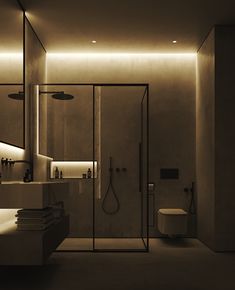 a bathroom with a shower, toilet and sink in it's center area at night