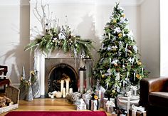 a living room with a christmas tree and fireplace