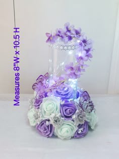 a vase filled with purple and white flowers