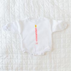 "This first birthday design includes a pink candle and is available in 8 different product types. It can read \"one\" as shown in the pictures, or alternatively, it can feature your little one's name in the personalization section. The design is printed on 100% cotton on either a short sleeve bodysuit, long sleeve bodysuit, sweatshirt romper, sleeper, or toddler sweatshirt, long sleeve, or short sleeve. This piece is a sturdy material, cozy soft and perfect for staying cuddly. Perfect for your babe's bday celebration. Sizing: long and short sleeves: true to size sweatshirt romper and sweatshirt: oversized sleeper: fits large sweatshirt: slightly oversized but more true to size This product is handprinted using nontoxic, water-based inks on a cotton sweatshirt material romper with three sna Pink Long Sleeve Top For Birthday, Personalized Pink Tops For First Birthday, Personalized Pink Top For First Birthday, Custom Pink Tops For First Birthday, Cupcake Shirt, Birthday Sweatshirt, Birthday Girl Outfit, 1st Birthday Outfits, Pink Candles