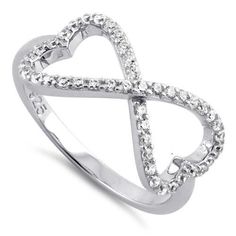 a white gold ring with diamonds in the shape of an interlocked heart, on a