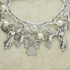 The Angel Charm Bracelet comes with several Angel Charms and Guardian Angel Charms with Clear Crystals and faux Pearls. The Link Bracelet is adjustable from 7 1/2 inches to 8 inches. A great gift for a Choir teacher, choir member, religious teacher, or Spiritual leader. A quick and easy gift for Communions, Confirmations, and Christmas. The Bracelet is packaged in a gift box for convenient gift giving. Let your guardian angel protect you as you wear this lovely, spiritual bracelet. Choir Teacher, Bracelet With Pearls, Angel Charms, Charm Bracelet Silver, Spiritual Bracelets, Angel Charm, Your Guardian Angel, Spiritual Leader, Gold Cross Pendant