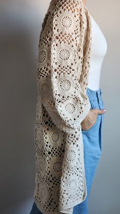 a woman is wearing a crocheted shawl