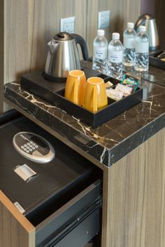 there is a tray with coffee and other items on the counter in this hotel room