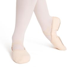 the feet of a child in ballet shoes