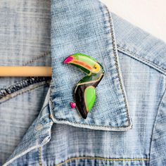 Add a touch of whimsical charm to any outfit with this Statement Toucan Bird Brooch.  This unique lapel pin is the perfect gift for any nature-loving bird nerd in your life.  Handcrafted with care, this nature jewelry piece makes for a thoughtful and memorable friend gift.  Other nature and animal brooches you can find here: https://www.etsy.com/shop/JewelryKatMade?section_id=28373902 Measurements of the brooch are: 5.4 x 4.9 cm.  Please keep in mind that colors may vary slightly from those view Unique Multicolor Enamel Pin For Gift, Unique Multicolor Enamel Pin Gift, Toucan Bird, Animal Brooch, Bird Brooch, Bird Jewelry, Gift For Boyfriend, Brooches Handmade, Nature Jewelry