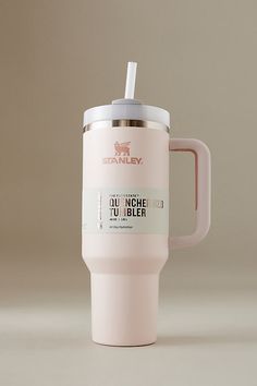 a pink coffee cup with a straw in it