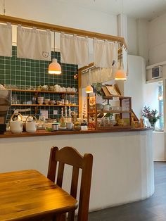 a restaurant with wooden tables and chairs in front of the counter