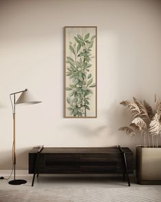 a living room with a plant on the wall next to a lamp and a couch