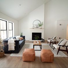 a living room filled with furniture and a fire place in the middle of a room