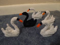 four black and white swans on a towel