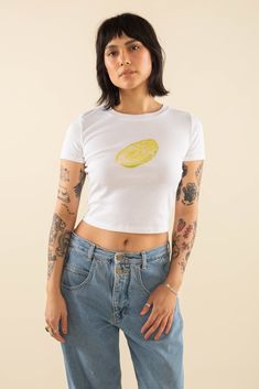 As part of the "farm-to-tee" collection, this 100% cotton short sleeve crewneck baby tee features a DTG Napa Cabbage vegetable print. Crew neck basic tee Fits close to body Crop/mid to sit just below waist Fabric is a cotton 1x1 rib knit Fit Kris is 5'7" and wearing size S View full Size Chart Content & Care 100% Cotton Machine wash cold. Tumble dry low. Summer Organic Cotton Tops, Organic Cotton Summer Tops, Organic Cotton Crew Neck Tops, Organic Tops With Graphic Print For Spring, Organic Crew Neck Tops For Spring, Organic Graphic Print Top For Spring, Organic Crew Neck Top For Summer, Organic Cotton T-shirt For Spring, Organic Cotton T-shirt For Summer