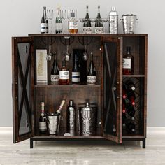 a wooden cabinet filled with bottles and glasses