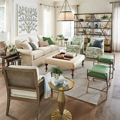 a living room filled with furniture and lots of windows