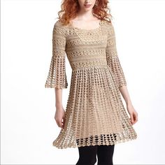 a woman wearing a dress with crochet on it