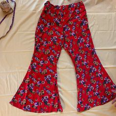 Red pants with a pretty floral print. HAS POCKETS! Flare leg bells. plus size 1x  Ready to ship with free shipping. Floral Print Flare Bottoms With Stretch, Bohemian Flare Pants With Floral Print, Stretch Red Floral Print Bottoms, Red Bohemian Wide Leg Pants For Spring, Red Floral Print Bottoms For Spring, Red Floral Print Spring Bottoms, Spring Red Floral Print Bottoms, Red Bohemian Pants With Floral Print, Red Flare Bottoms For Summer