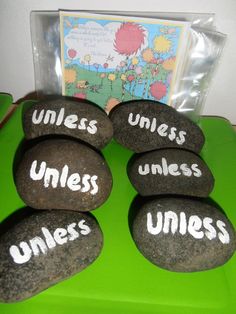 rocks with words written on them sitting in front of a card and some other items