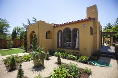 a house that has some plants in front of it