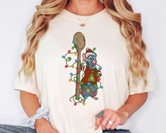 a woman wearing a t - shirt with a koala holding a christmas tree on it