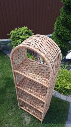 a wicker shelf sitting in the grass