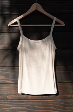 A 90's inspired elevated wardrobe essential. Made of locally sourced buttery soft upcycled rib, the Soleil is a tank top with a snugly fitting gently curved neckline, bra-friendly straps, and falls to high hip length. We consider this one true to size, and if in-between could be sized either up or down based on your preference. Made to layer - choose a pair and receive $10 off both (automatically applied at checkout). Beige Cotton Tank Top With Built-in Bra, Loungewear Camisole With Adjustable Straps And Scoop Neck, Fitted Tank Top With Spaghetti Straps For Everyday, Fitted Everyday Tank Top With Spaghetti Straps, Scoop Neck Camisole With Adjustable Straps For Loungewear, Fitted Spaghetti Strap Tank Top For Everyday, Seamless Fitted Tank Top With Spaghetti Straps, Beige Cotton Camisole With Tank Straps, Seamless Sleeveless Camisole