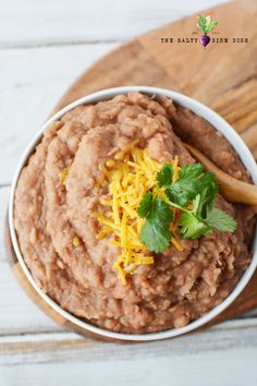 a bowl filled with refried beans and topped with cheese