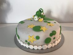 a green and white cake sitting on top of a table