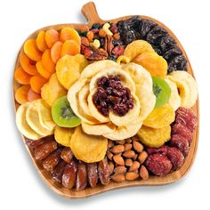 an apple shaped platter filled with dried fruits and nuts