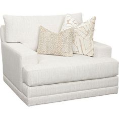 a white couch with two pillows on it's back and one pillow in the middle