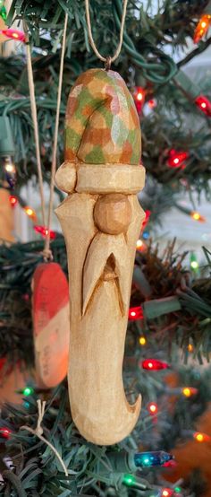 a wooden ornament hanging from a christmas tree