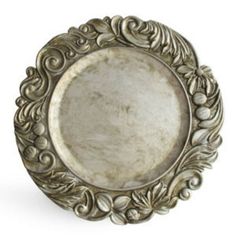 an ornate silver plate with leaves and scrolls on it's rim, isolated against a white background