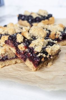 blueberry crumb bars are stacked on top of each other