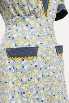 a blue and yellow dress with pockets on it