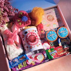 a pink box filled with candy and candies