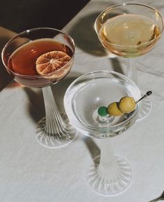 two wine glasses filled with different types of drinks