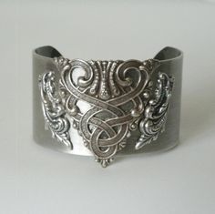 Celtic Bracelet This beautiful silver plated cuff bracelet has a silver plated celtic knot design.  1.5 inches wide. All components are nickel and lead free sterling silver plated over stainless steel. Hypoallergenic for no skin irritations or discolorations. The plating is high quality and will not chip or peel off. gothic victorian art deco renaissance celtic medieval style Unique Antique Silver Bracelet For Wedding, Vintage Silver Jewelry With Historical Design, Antique Silver Nickel-free Cuff Bracelet, Elegant Antique Silver Cuff Bracelet, Elegant Engraved Antique Silver Cuff Bracelet, Silver Jewelry With Historical Design As Gift, Vintage Nickel-free Cuff Bracelet For Weddings, Silver Jewelry With Historical Design For Gift, Nickel-free Vintage Cuff Bracelet For Wedding