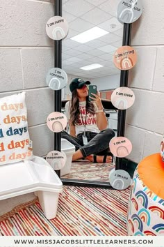 a woman taking a selfie in front of a mirror with her cell phone and other items