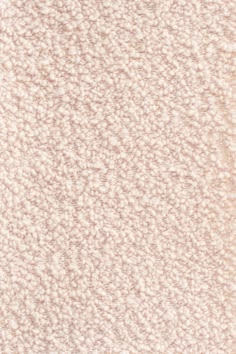 a white carpet textured with some light brown and cream colors on the bottom half