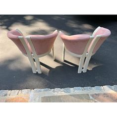 two pink chairs sitting next to each other