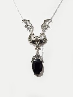 ◆ Silver plated gothic necklace with bat and black crystal. The crystal measures 0,984252 x 0,708661 inches and is very bright, the jewel is embellished with a cameo with Victorian decorations. All necklaces in my shop are adjustable in length, but if you have demanding details you can safely contact me! ❤ The product is handmade with great care. ♡ In my shop there are many handmade jewelry for sale for all tastes, come and look at them you are welcome! ♡ ❤ Do you need a custom order? ❤ You can enter a free note to send together with your purchase, or you can contact me if you need any information. ✮ How will your jewelry be packaged? ✮ All my jewelry are sent together with a card, in a clear cellophane package and placed in an elegant free black organza gift bag. If you need a gift box wi Gothic Pendant Necklace For Halloween, Halloween Gothic Pendant Necklace, Black Vampire Jewelry For Halloween, Vampire Style Black Jewelry For Halloween, Halloween Gothic Pendant Jewelry, Gothic Metal Necklace, Elegant Halloween Pendant Necklace, Gothic Metal Necklaces With Jewels, Black Vampire Pendant Jewelry