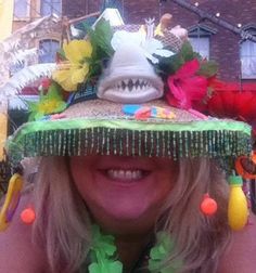 a woman wearing a hat with decorations on it