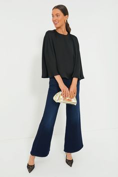 Flowy, feminine, and fabulous, the Black Satin Twill Selma Cape Blouse is the effortlessly elevated style you've been searching for. With a classic round neckline, swingy cape sleeves, and a cropped hem length to balance out the slightly boxy fit, this top is the kind of piece that lends itself to evening ensembles. Pair it with slim black trousers and heels to create a sleek set, or try it with dark wash denim and booties for a date night outfit that's sure to earn you some compliments. Round n Cape Blouse, Dinner Dates, Gold Clutch, Elevated Style, Cape Sleeves, Cocktail Parties, Silk Maxi Dress, Loeffler Randall, Flutter Sleeve Top