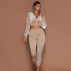 A little casual a lot of sexy... this jogger pant set has it all. Featuring a cropped zippered jacket with elastic trim and fitted jogger pants with an elastic waist in soft & comfy velvet finish. Made with a cotton blend and comes in three fabulous colors from which to choose. Velvet Joggers Outfit, Joggers Outfit Casual, Blazer E Short, Suede Suit, Crop Top Pants Set, Velvet Tracksuit, Velvet Joggers, Velvet Set, Velvet Suit