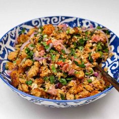 a blue and white bowl filled with food