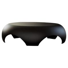 a black table that is sitting on a white surface and has an open mouth design