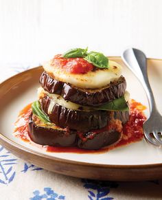 an eggplant dish on a plate with sauce