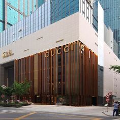 a large building with wooden slats on the side and people walking in front of it